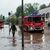 Feuerwehrleute bewegen sich durch das Hochwasser in Saarbrücken. - Foto: Harald Tittel/dpa