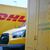 Auch er fährt Stromer: ein DHL-Paketbote auf dem Weg zu seinem Elektro-Transporter. - Foto: Wolf von Dewitz/dpa