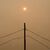 Rauch verdeckt die Sonne, während Waldbrände im Norden Manitobas wüten. - Foto: David Lipnowski/The Canadian Press/AP/dpa